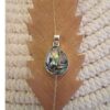Close-up of iridescent abalone shell teardrop pendant in silver bezel