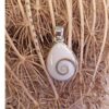Silver Shiva Eye shell pendant with golden-brown spiral, 2.5 x 1.5 cm